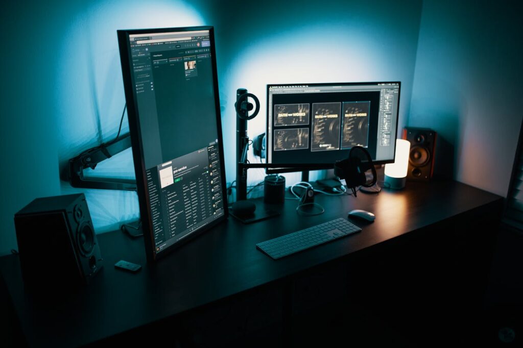 pexels photo 1714208 A contemporary office desk featuring a dual monitor setup with stylish lighting, ideal for tech enthusiasts.