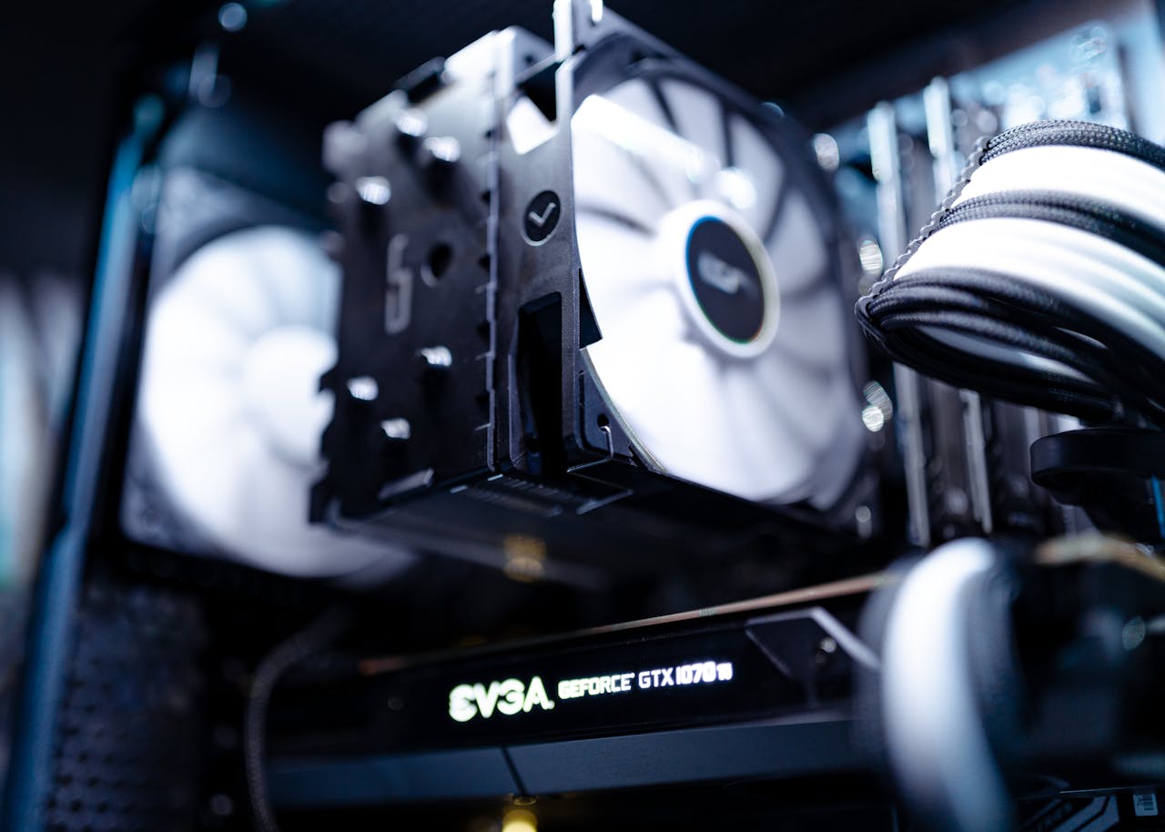 gallery-1 Detailed view of a cooling fan inside a modern gaming PC setup.